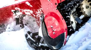 Closeup of rotor on a snowblower collecting snow.  